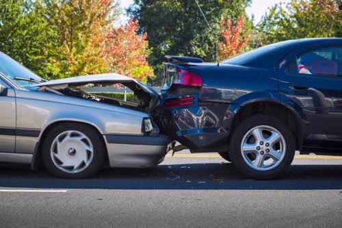 A rear-end Uber accident between two sedans.