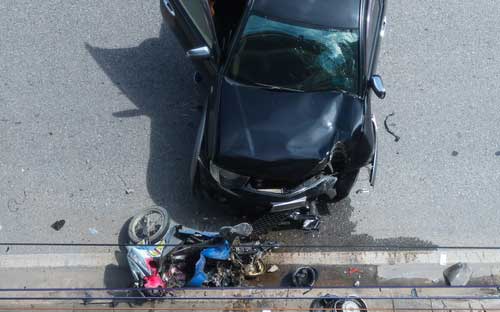 A car that has hit a motorcycle. 